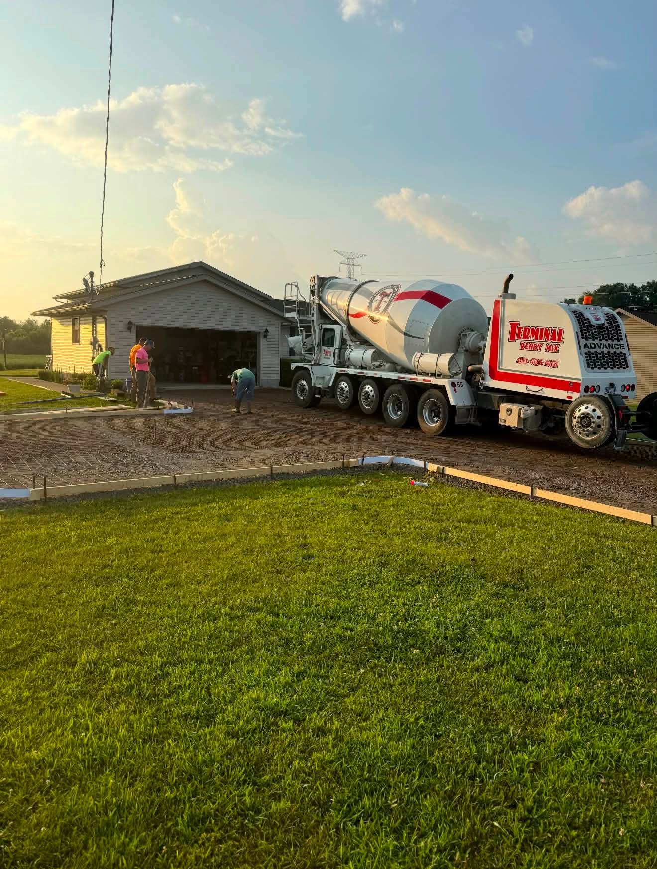 Crew placing concrete for a large driveway